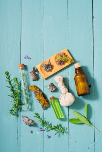 Flatlay of herbs and bath additives in test tubes and apothecary bottle